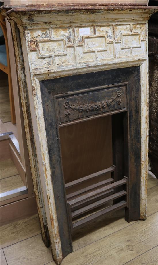 A pair of small Victorian cast iron fire surrounds W.70cm